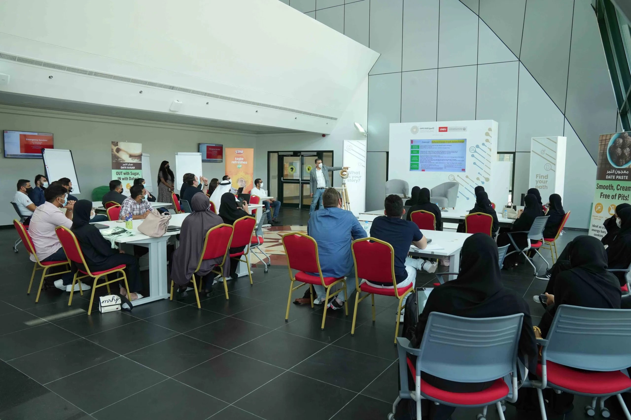 Attendees sitting at tables in a conference room, participating in a meeting or workshop